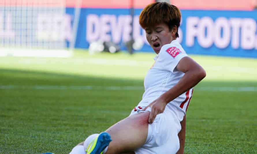 Lou Jiahui of China reacts after sliding on the artificial turf.