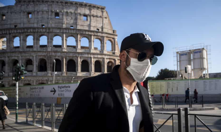 A tourist wearing a face mask visits the Colosseum in Rome, Italy, on 24 February.
