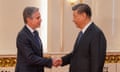 Antony Blinken and Xi Jinping shake hands in the Great Hall of the People in Beijing.