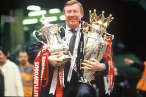 Sir Alex Ferguson, the manager of Double winning Manchester United, shows off the FA Cup and Premiership trophy in May 1996.