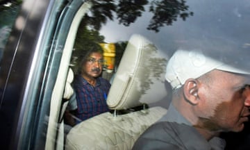 Arvind Kejriwal leaves court by car after attending a hearing in New Delhi.