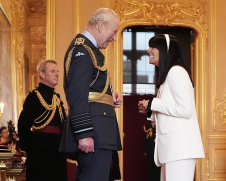King Charles and Claudia Winkleman laugh together as she accepts her MBE