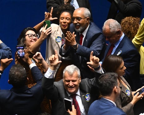 Senators celebrate the approval of a constitutional amendment bill that would end shorten the workweek in Brazil.