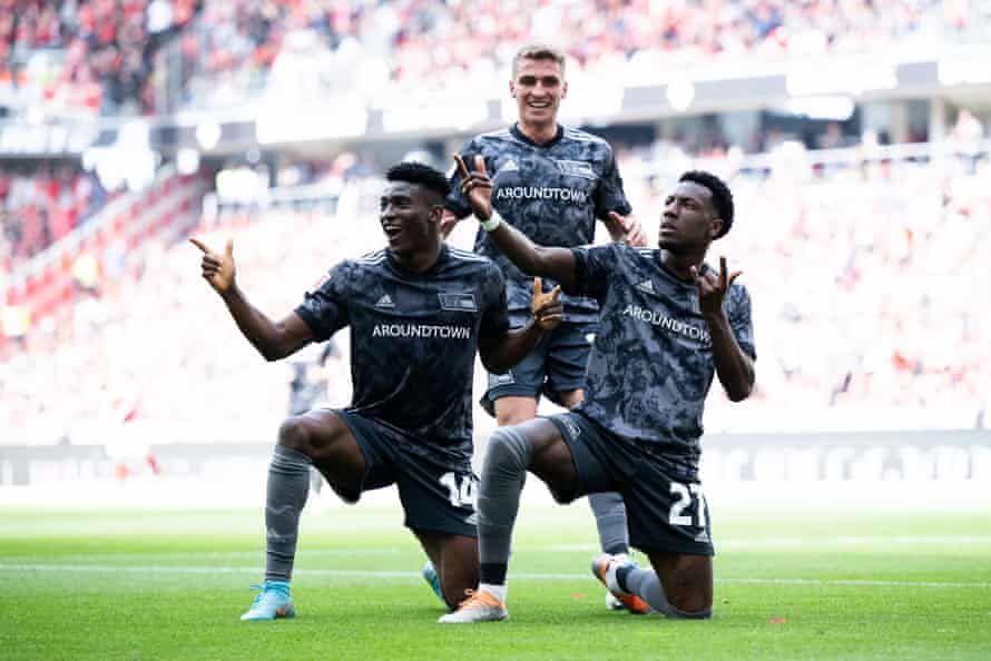 Sheraldo Becker of Union Berlin celebrates with Taiwo Awoniyi (left) and Grischa Proemel (centre) after scoring the third goal against Freiburg.