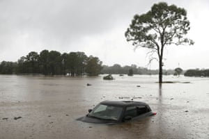 Sydney, Australia: A partially submerged car left abandoned in the suburb of Windsor after widespread flooding in New South Wales.