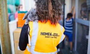 A volunteer holds a rabbit at the Homeless One soup kitchen in Digbeth, Birmingham