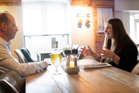 Julian and Livvy chatting across a restaurant table