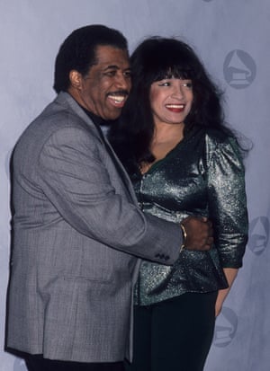 A man stands with his arm around a woman for a portrait