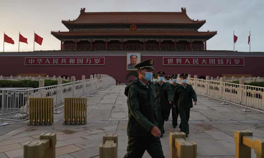 Members of the Chinese People’s Armed Police march through Tiananmen Gate