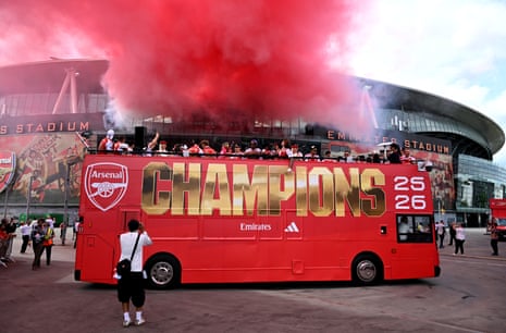 Arsenal players on top of their bus