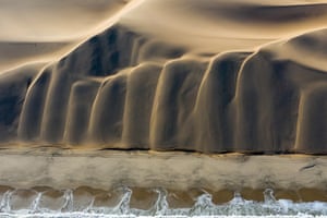 Nature. First classified: Meeting by David RougeThe meeting of the desert and the ocean. As the drone climbed higher, the photographer noticed the light highlighted the shapes of the dunes flowing into the southern Atlantic Ocean