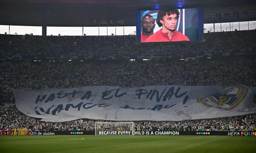 Real Madrid fans inside the stadium display a tifo as the players take to the pitch.