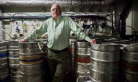 Steven Rowlands, landlord of the Tipperary, surrounded by kegs full of Guinness and other drinks.