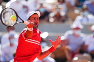 Novak Djokovic flings a forehand.