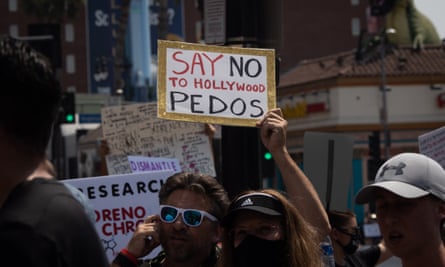 A man holds a sign condemning supposed pedophilia in the film industry, in Hollywood on 22 August.
