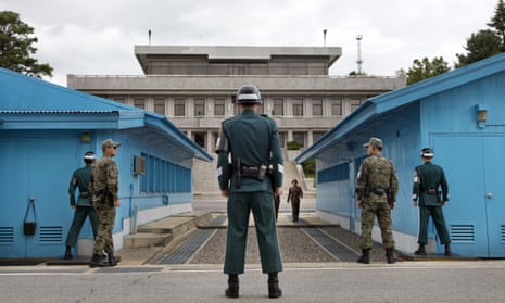 South Korean soldiers look towards the North Korean side in the military border village at Panmunjom.
