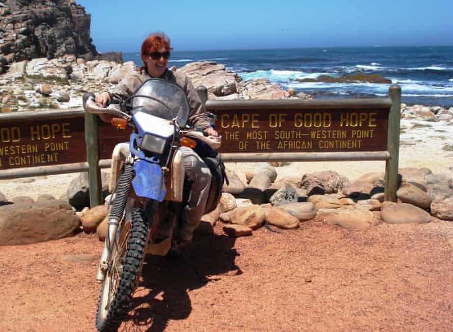 Lois Pryce and her trusty motorbike at the Cape of Good Hope, South Africa.