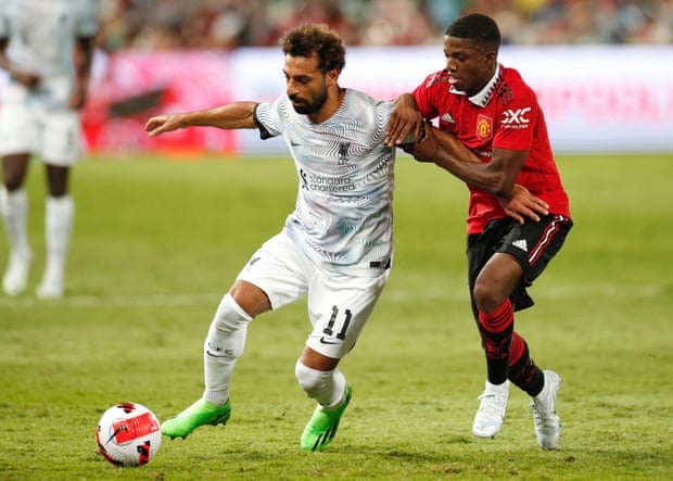 Liverpool’s Mohamed Salah tries to hold off the new Manchester United signing Tyrell Malacia.