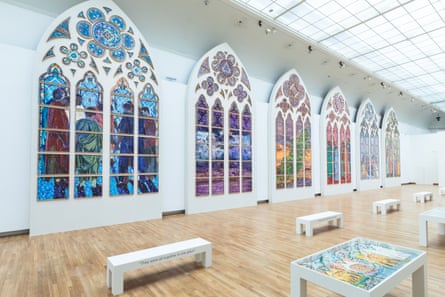 View down the gallery showing designs for six stained-glass windows.