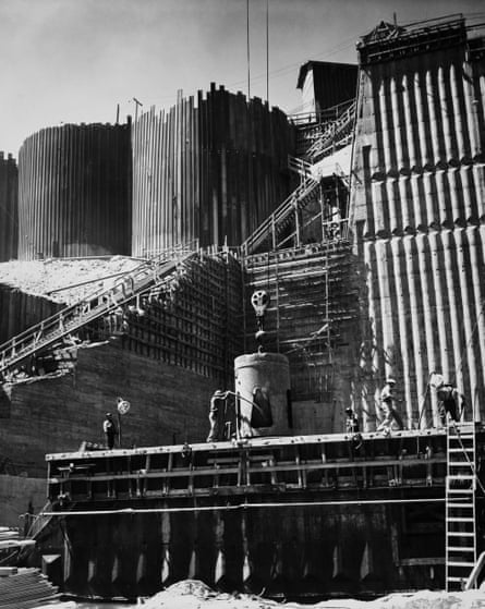 Construction workers build dam