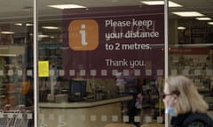 A sign requesting people stay two metres apart in a supermarket window