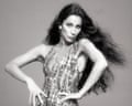her poses with hands on hips in a sparkling sequined Bob Mackie dress