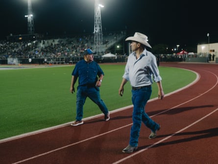 Man in cowboy hat at high school football game
