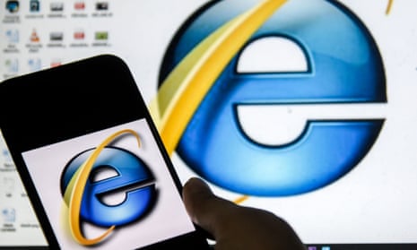 Microsoft Internet Explorer web browser logo seen displayed on a smart phone in front of a computer