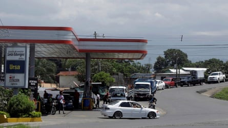 Automobiles line up for gasoline at a petrol station in Alajuela, Costa Rica