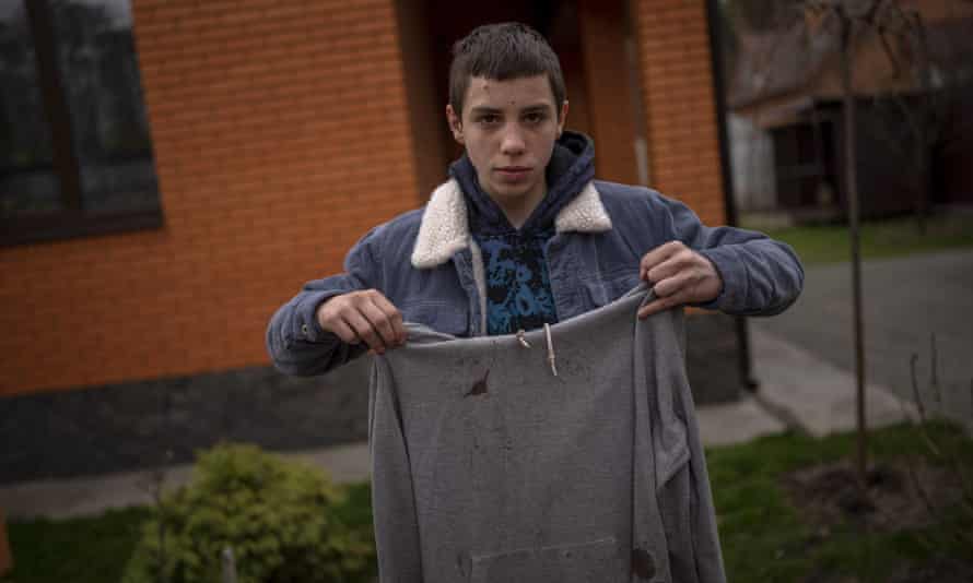 Nechyporenko holds the hoodie he was wearing the day a Russian soldier tried to kill him. The hoodie, bloodied at the elbow where a bullet pierced him, is now the centerpiece of the family’s search for justice
