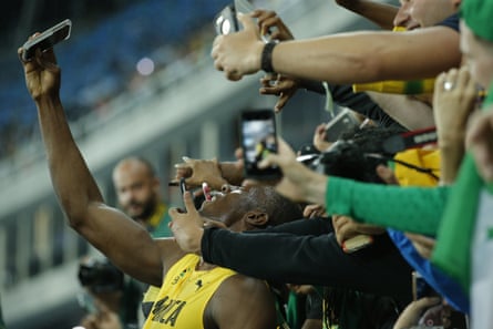 Usain Bolt, ever the crowd pleaser, takes selfies with his fans.