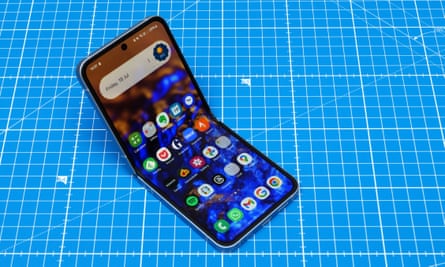 An open Samsung Galaxy Z Flip 6 on blue graph paper