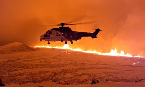 This image made from video provided by the Icelandic Coast Guard shows its helicopter flying near magma running on a hill near Grindavik on Iceland's Reykjanes Peninsula sometime around late Monday, Dec. 18, or early Tuesday, Dec. 19, 2023.