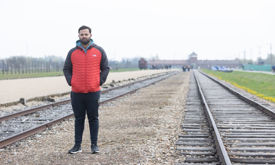 Azeem Rafiq by the railway tracks leading to Auschwitz-Birkenau
