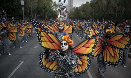 Women dressed as monarch butterflies perform during the Day of the Dead Parade in Mexico City on 27 October 2019 in Mexico City.