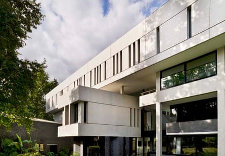 A brutalist structure with clean angles and square and slit windows photographed on a sunny day.