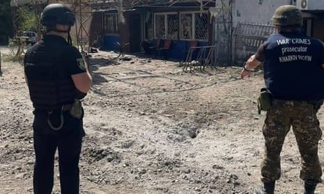 War crimes prosecutors inspecting a shelling in the village of Podoly near Kupiansk, Kharkiv region