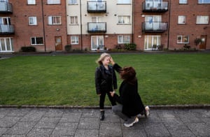 Six-year-old Annalee Corcoran receives ashes from her Aunty Maria outside their home in Meakstown, Dublin, Ireland