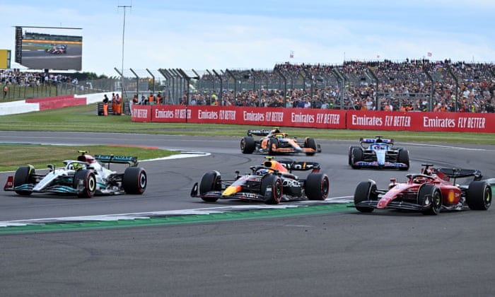 Side-by-side: Charles Leclerc (R) and Sergio Perez (M) run wide allowing Mercedes’ British driver Lewis Hamilton to move up two places