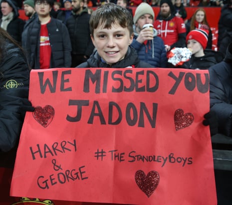 A fan holds a sign welcoming back Jadon Sancho of Manchester United ahead of the Carabao Cup Semi Final second leg against Nottingham Forest.