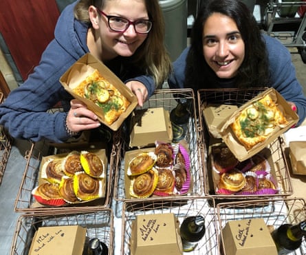 Vikki and Nadisha, international students and employees of The Swedish Baker, pose with some of their merchandise.