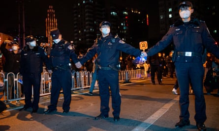 Police officers stand guard during a protest against zero-Covid policies in Beijing on Sunday.