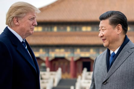 Two men facing each other and smiling tightly.