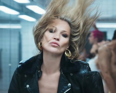 Kate Moss in a leather jacket, with her hair flying upwards
