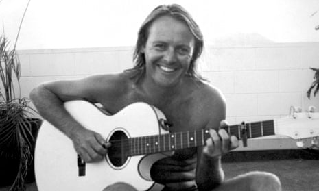 Former AC/DC manager Crispin Dye playing a guitar. He was fatally attacked in Sydney in 1993