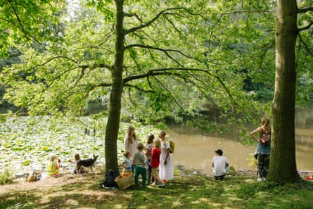 People under trees by a lake