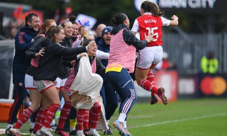 Katie McCabe (right) is mobbed by her teammates after scoring the winner for Arsenal. 
