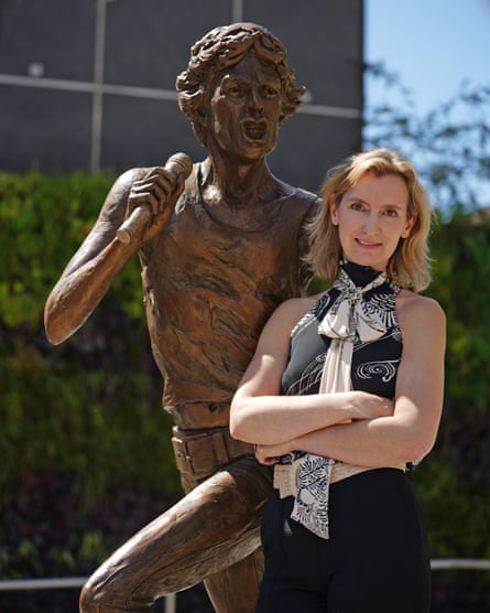 Amy Goodman with Mick Jagger statue.