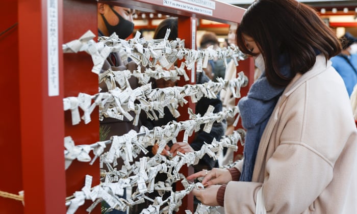 A woman wears a face mask during a visit to the Sensoji Temple in Asakusa ahead of the upcoming New Year.