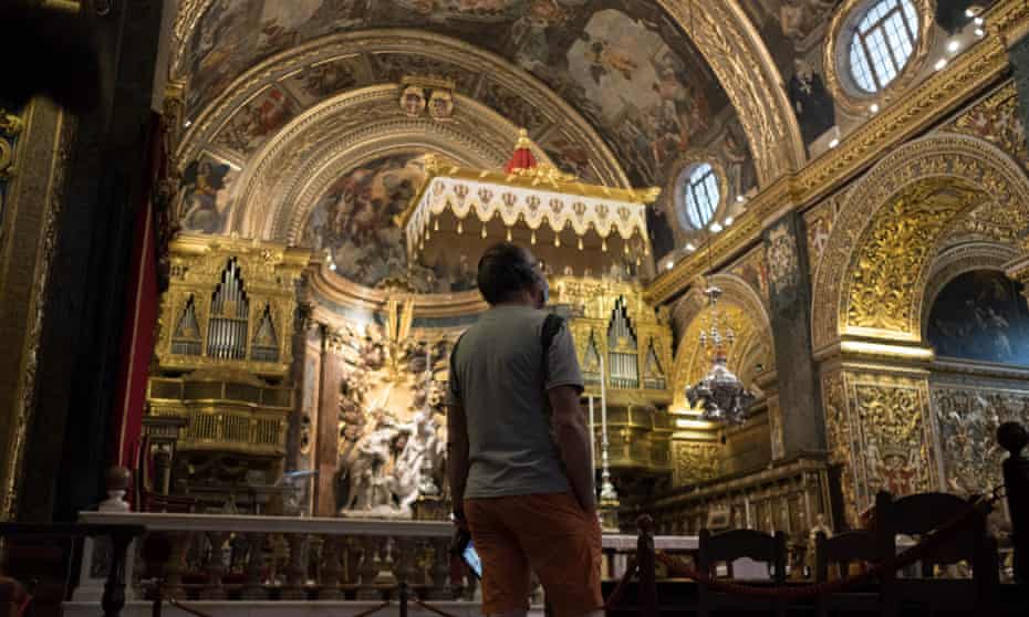 A tourist looks up at the ceiling of St John’s Co-Cathedral in Valletta, Malta.